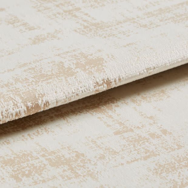 Crushed-velvet fabric with beige abstract patternâ€”folded and overlapped to reveal nap and edge; close-up, studio-lit view emphasizing soft texture and subtle sheen.