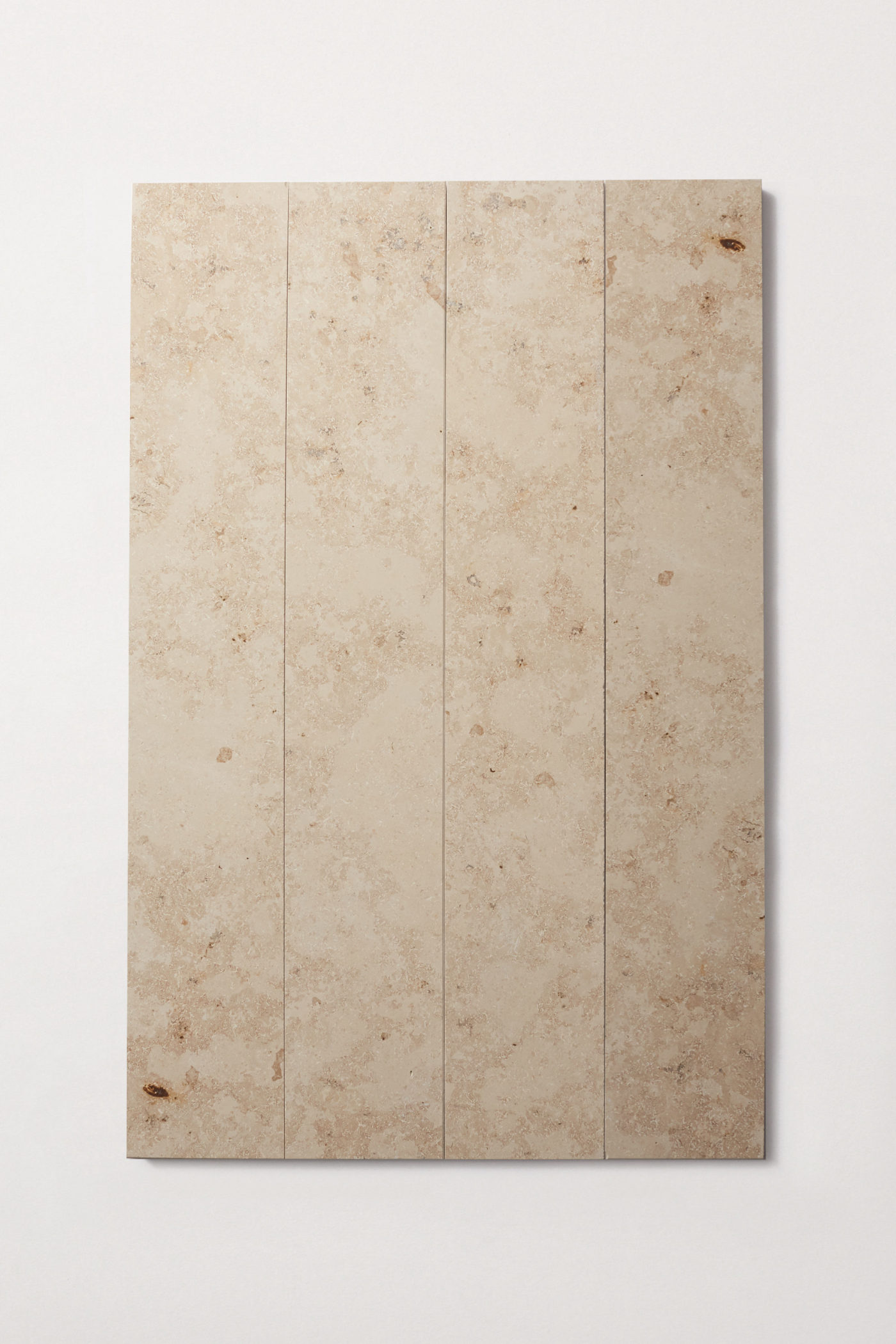 four long rectangular limestone tiles on a white surface.