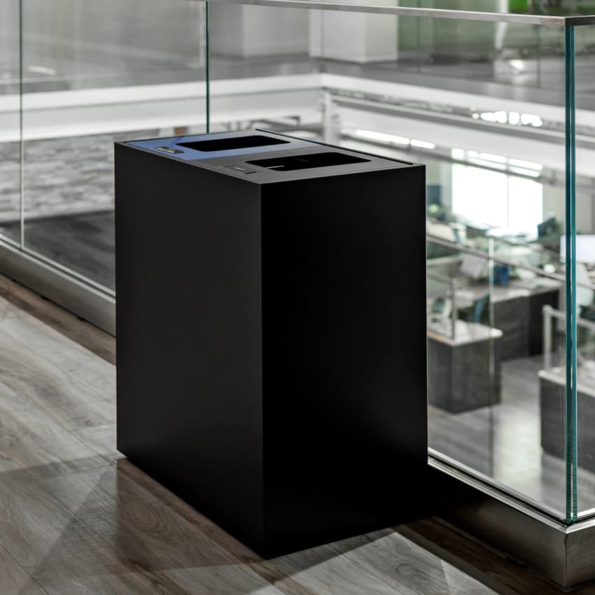black powder coated steel recycling and trash bin in a modern office environment