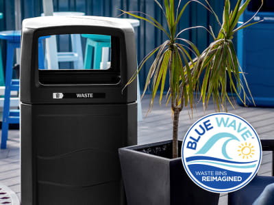 recycled plastic waste container with canopy lid and waste labels outside on a rooftop patio bar