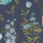Floral sprigs and blossoms repeat across a dark slate-blue background; stems and leaves interweave, with small white, pink and yellow clustered flowers forming a vintage botanical wallpaper pattern.