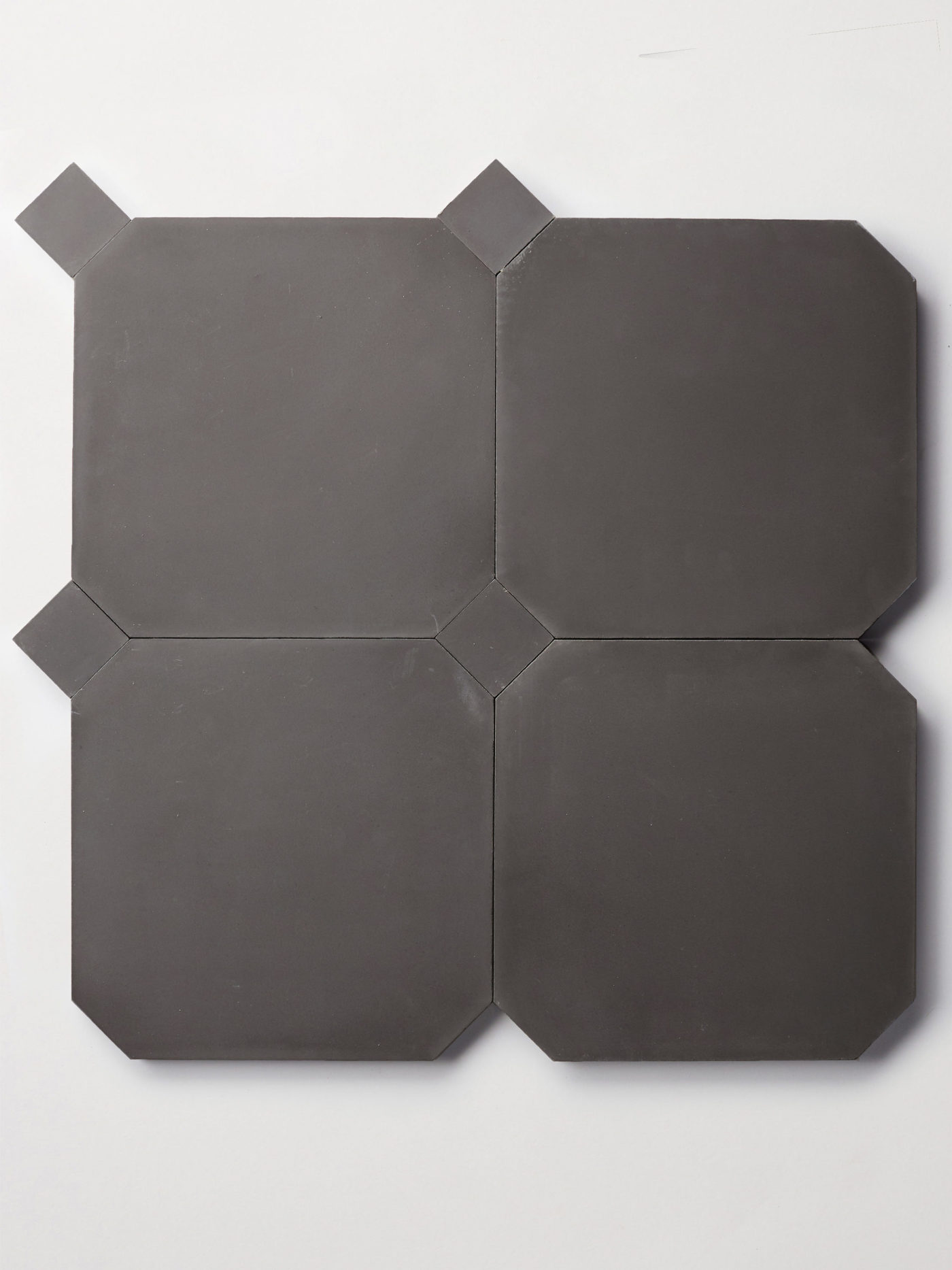 a set of black tiles on a white surface.