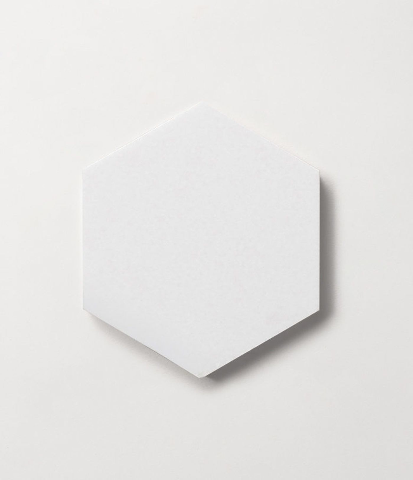 a white hexagonal tile on a white surface.