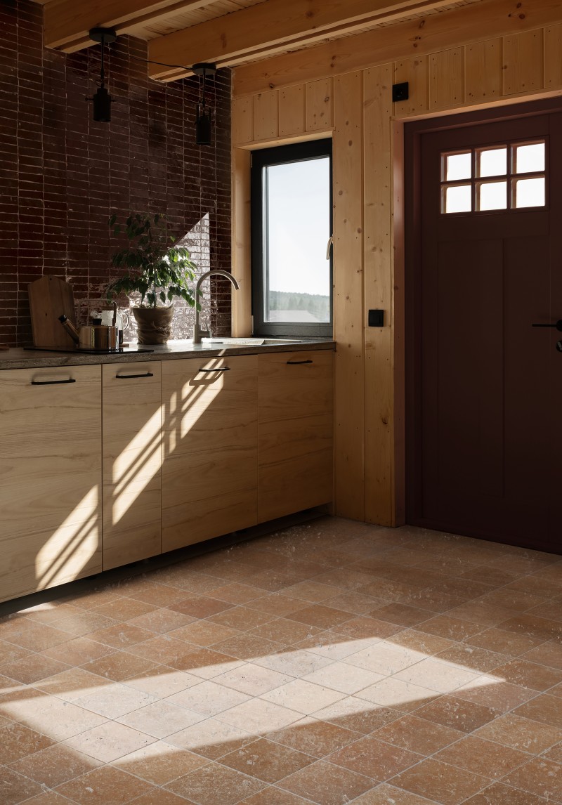 a kitchen with a wooden floor and tiled walls.