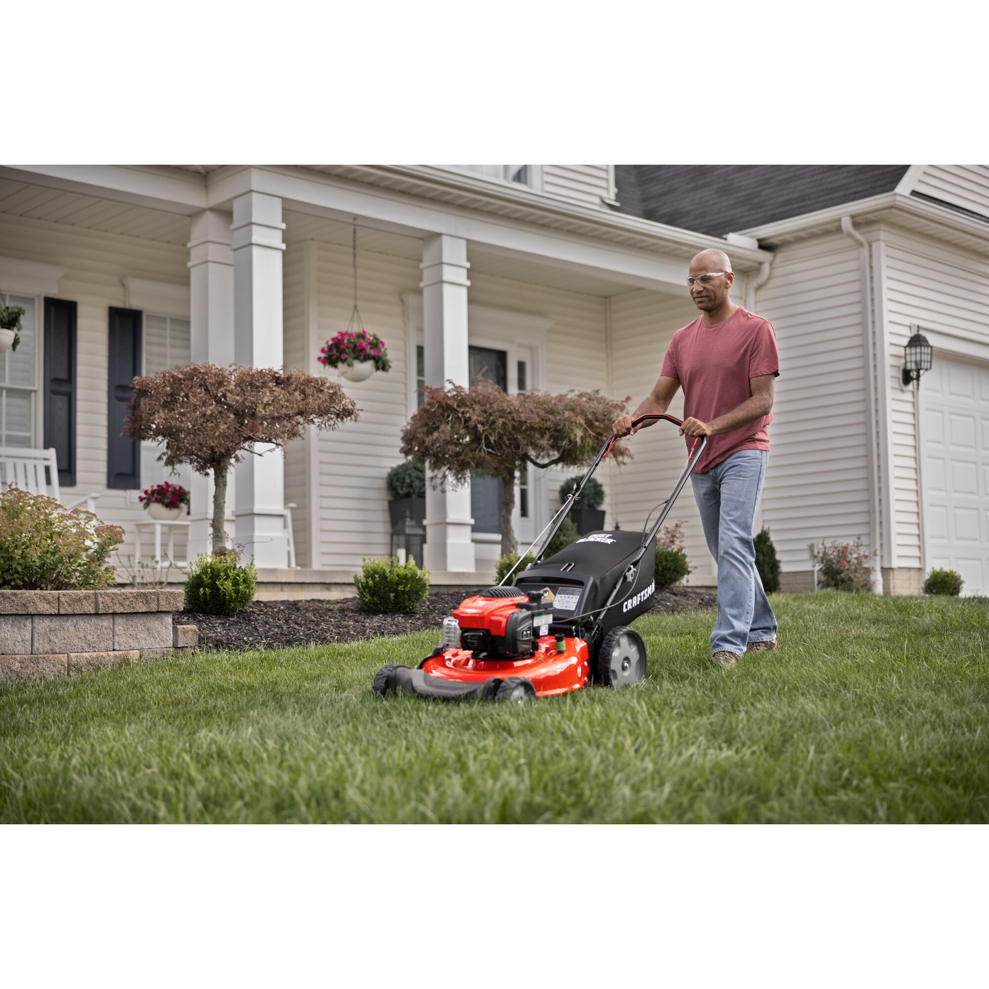 CRAFTSMAN 21-in 150cc Gas Push Mower mowing yard in front of house