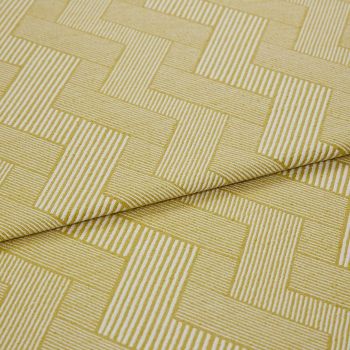 Folded mustard-yellow woven fabric with white narrow-striped, interlocking rectangular (herringbone-like) pattern — folded once — shown close-up on a flat surface under soft, neutral studio lighting.