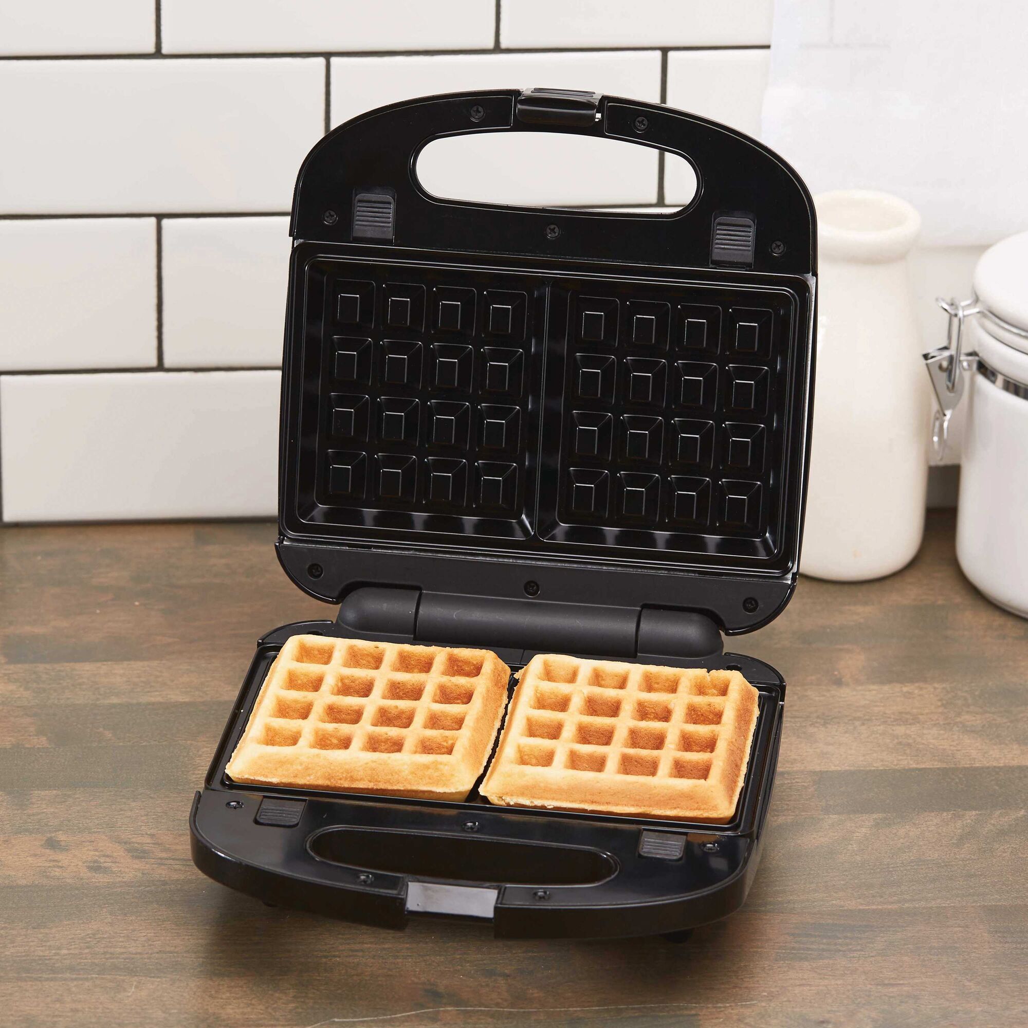 Waffle Maker Grill or Sandwich Maker with Stainless Steel Accents being used to make waffles.