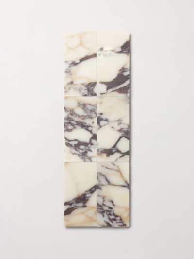 a white and black marble tile hanging on a wall.