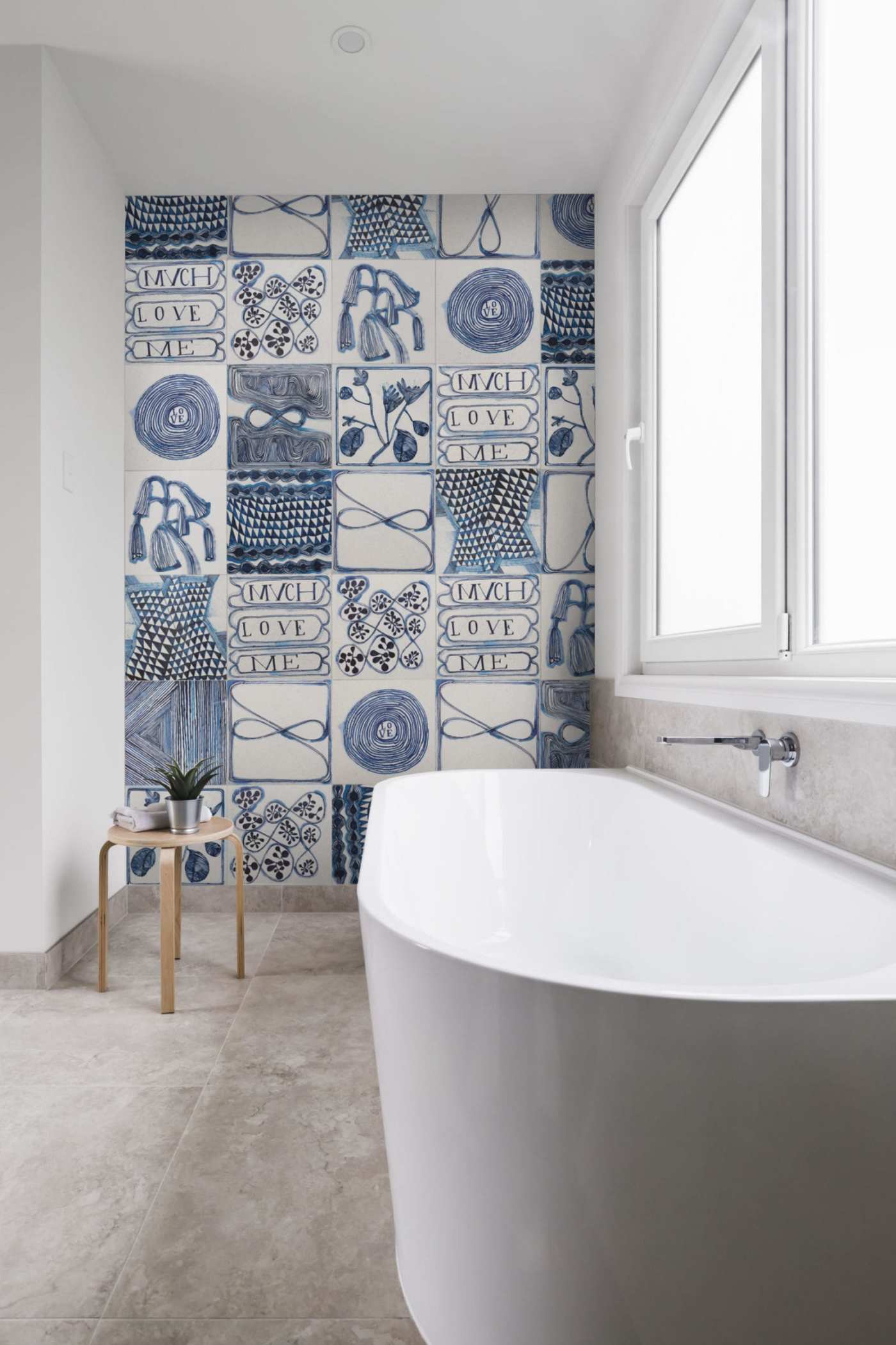 a bathroom with a blue and white patterned tiled wall.