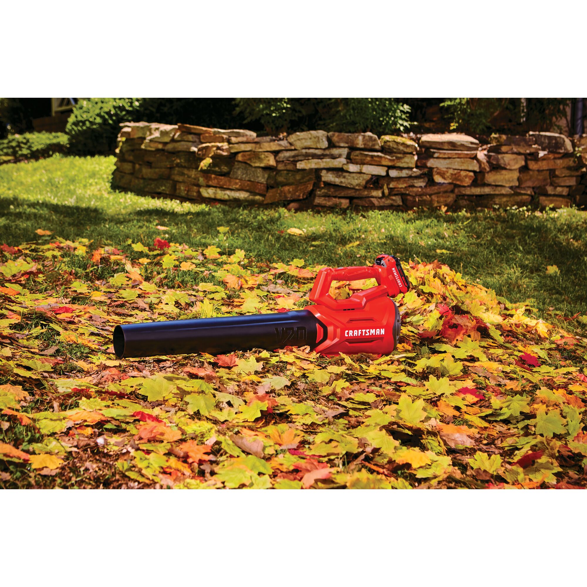 Cordless axial leaf blower kit 2 amp hour placed in lawn.