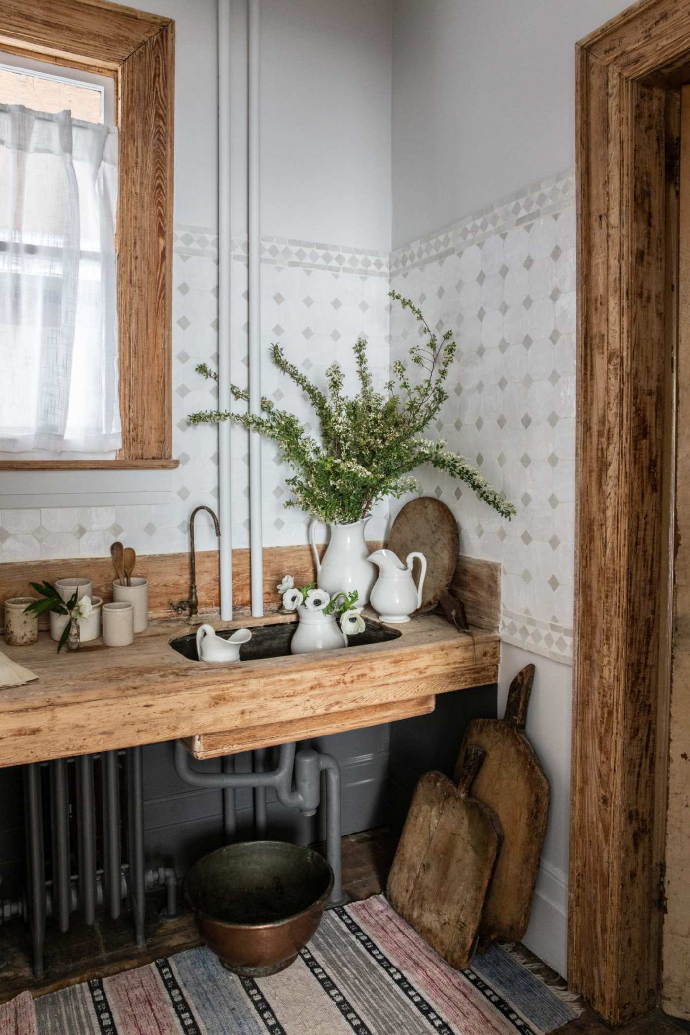 a kitchen corner with a sink and a window.