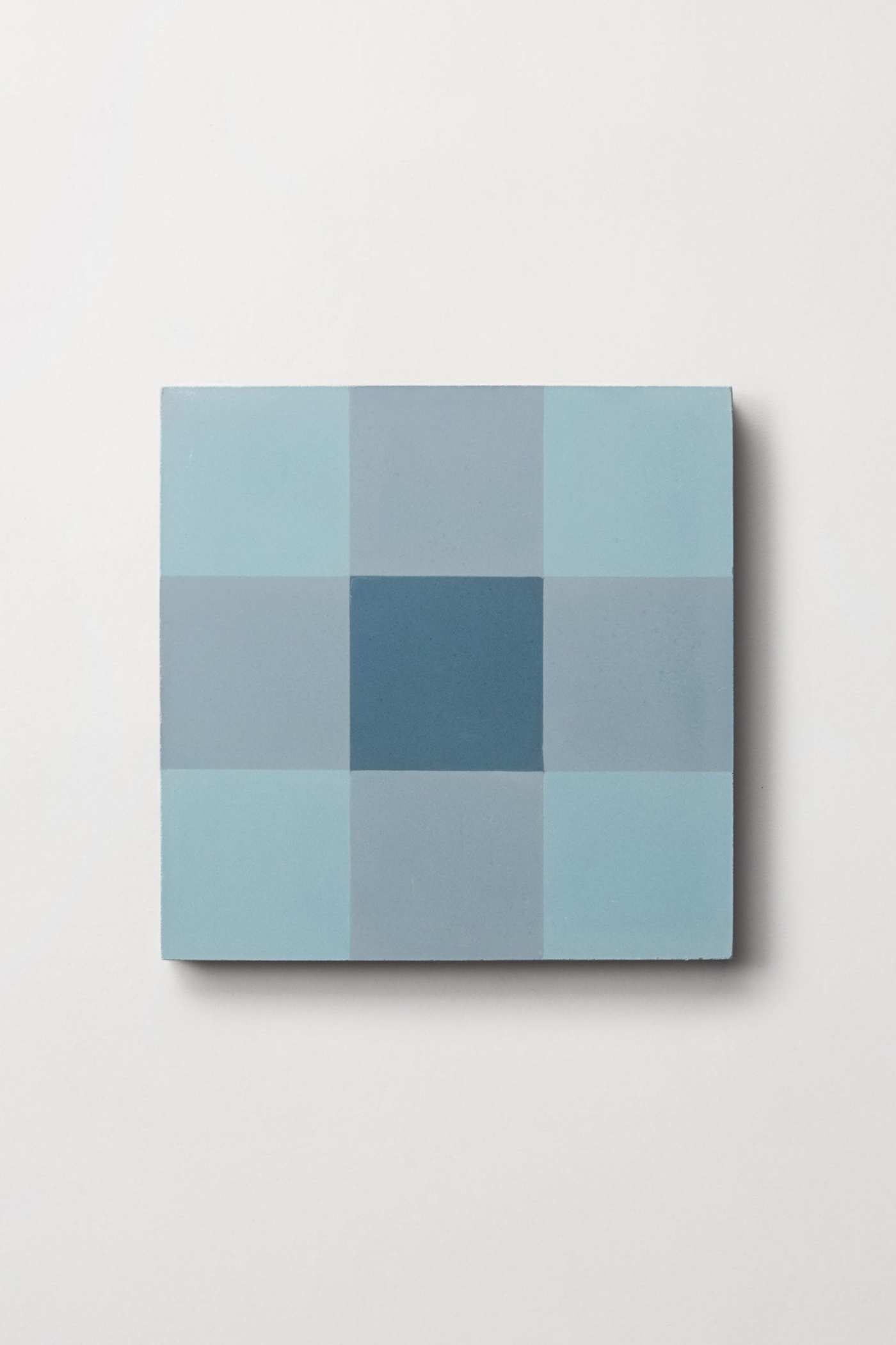 a blue checkered square tile on a white background.