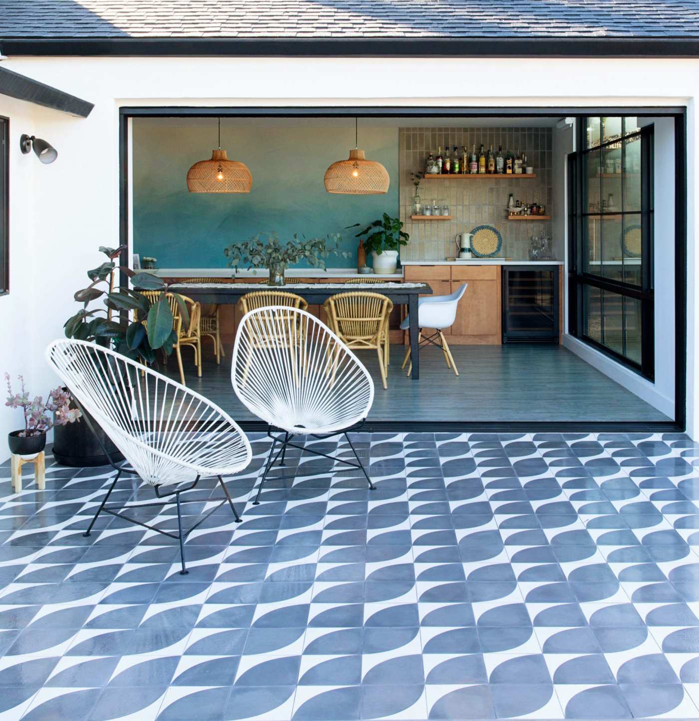 a patio with a blue and white tiled floor.