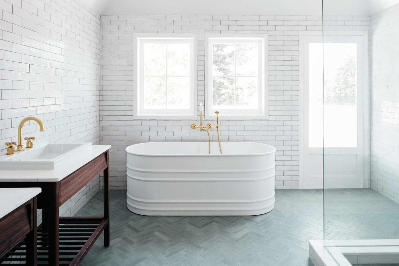 a white bathroom with a tub and sink.