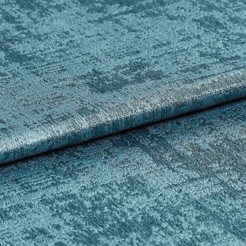 Teal crushed-velvet fabric sample, folded and shimmering, revealing irregular crushed texture; close-up studio view with soft directional lighting emphasizing the metallic sheen.