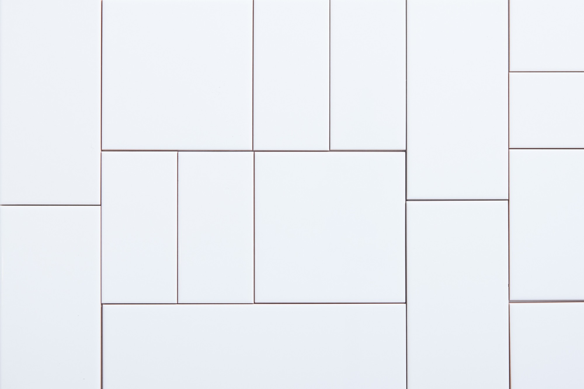 a close up of a white tile surface.