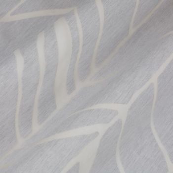 Pale gray curtain fabric with white abstract leaf pattern, draped in soft diagonal folds; fabric appears slightly textured and creased, shown in a close-up under soft, neutral indoor lighting.