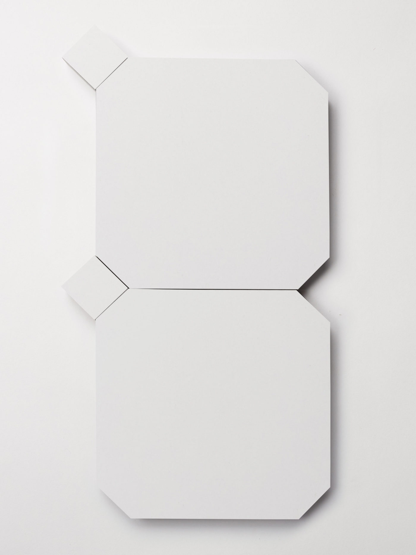 a set of white tiles on a white surface.