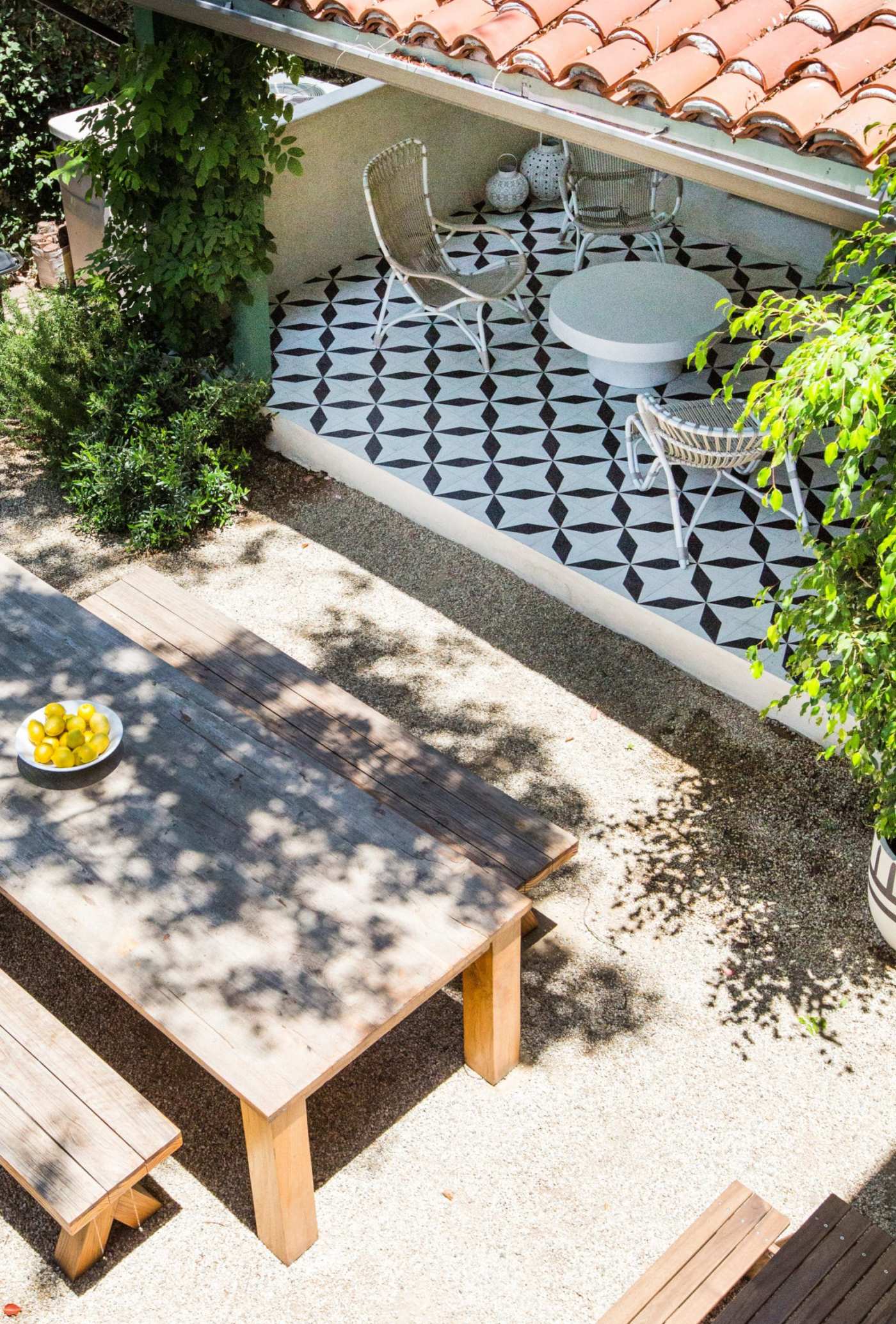 a tiled patio with a table and chairs.