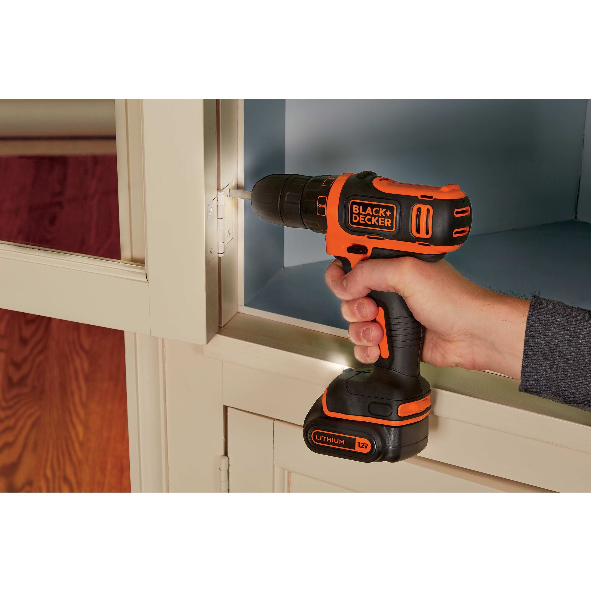 Cordless Lithium Drill Driver being used to tighten screws of cabinet door.