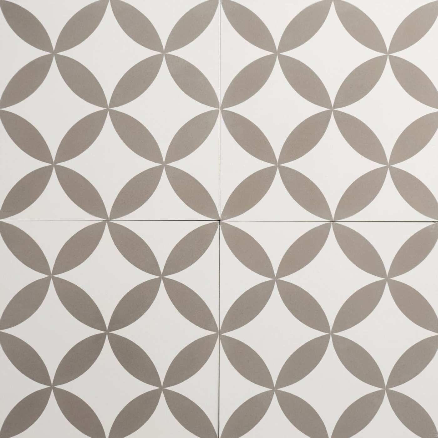 a surface with four grey and white patterned tiles.