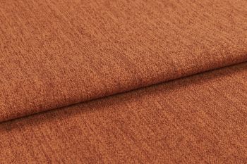 Burnt-orange textured fabric (upholstery cloth) folded once, overlapping edge casting a soft shadow; close-up studio view highlighting its nubby weave and warm, evenly lit surface.