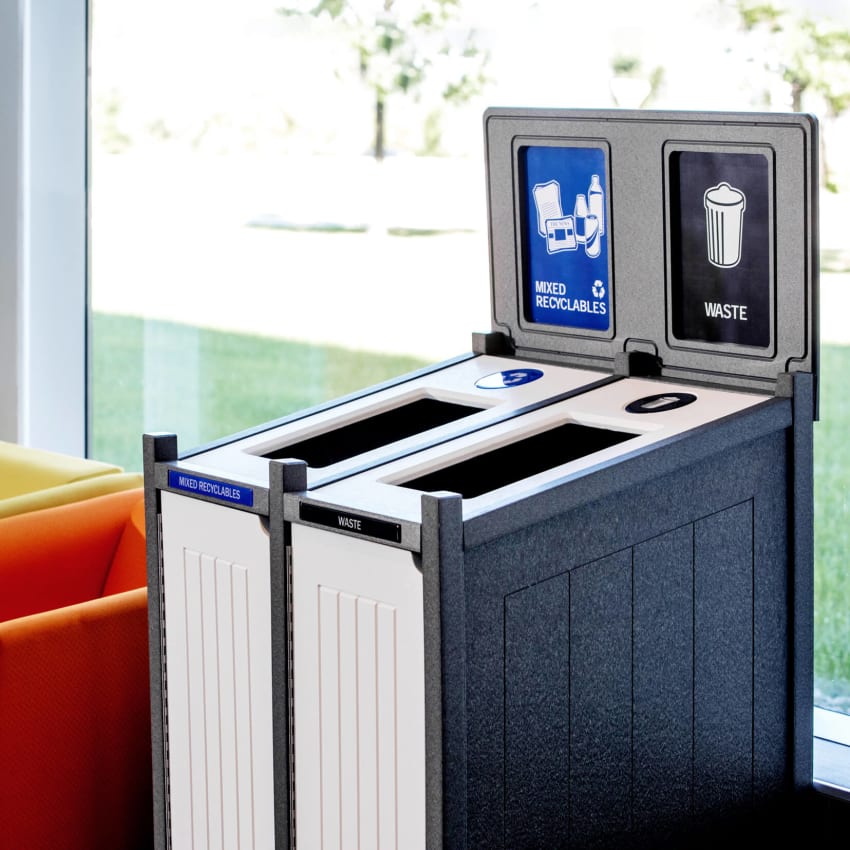 mixed recycling and trash container in an upscale office space beside a window