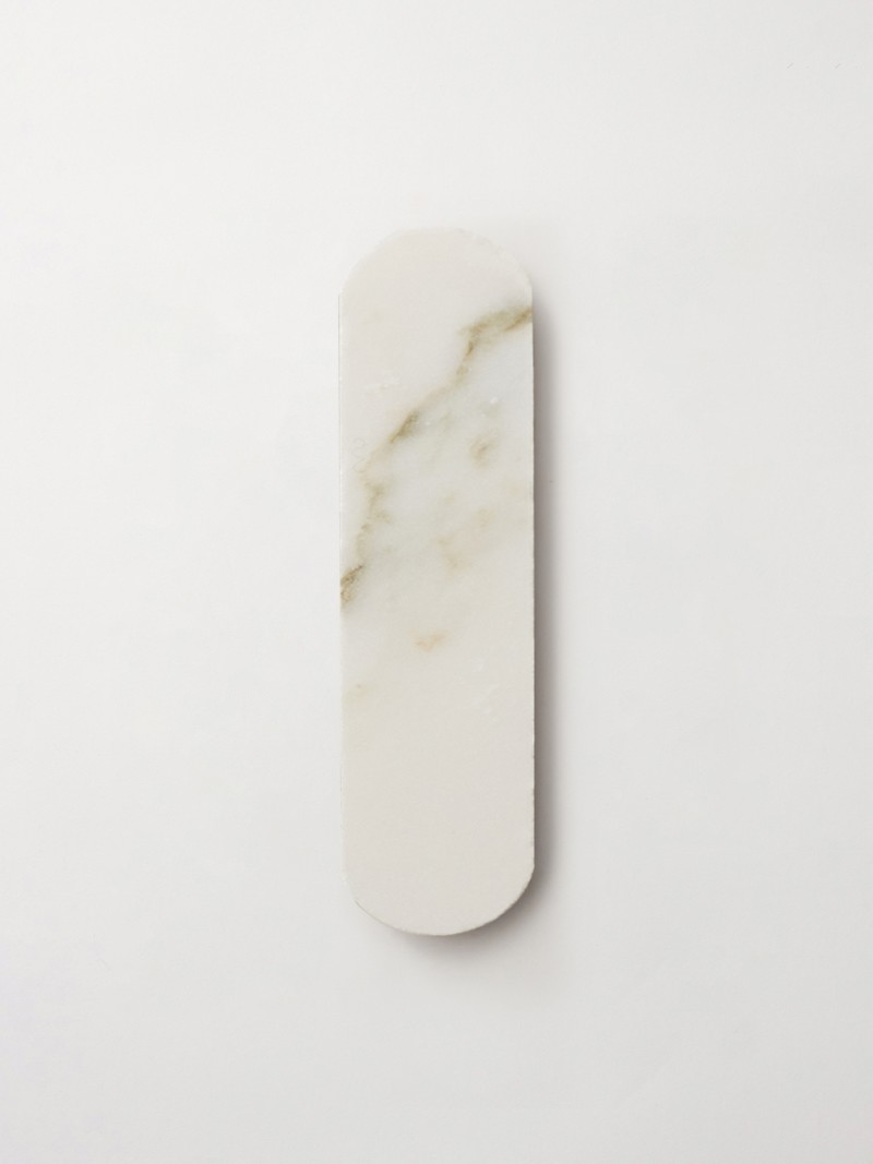 a white marble tray on a white surface.