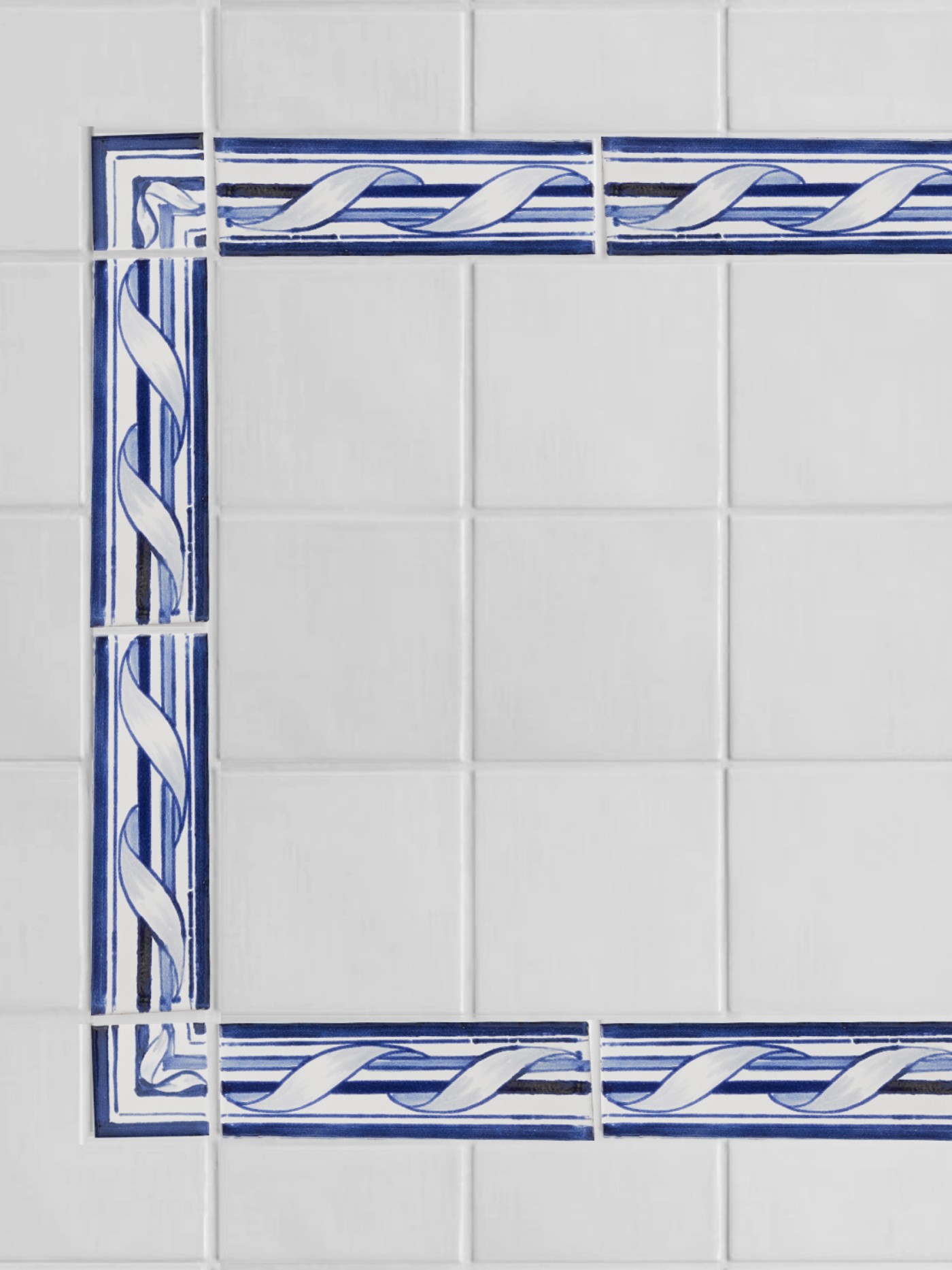 a blue and white tile border pattern in a bathroom.