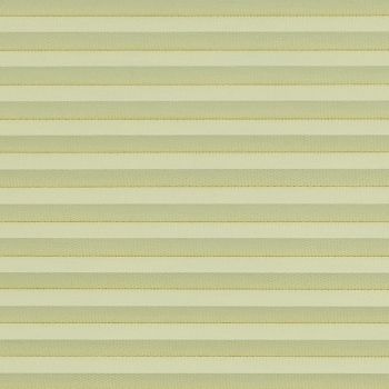 Honeycomb cellular blind with horizontal pleats, fully lowered and closed, diffusing soft daylight; close-up interior view showing uniform pale-yellow bands filling the frame.