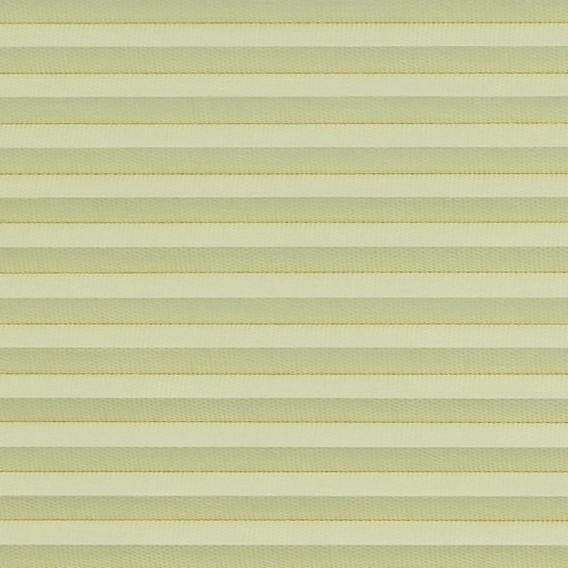 Honeycomb cellular blind with horizontal pleats, fully lowered and closed, diffusing soft daylight; close-up interior view showing uniform pale-yellow bands filling the frame.