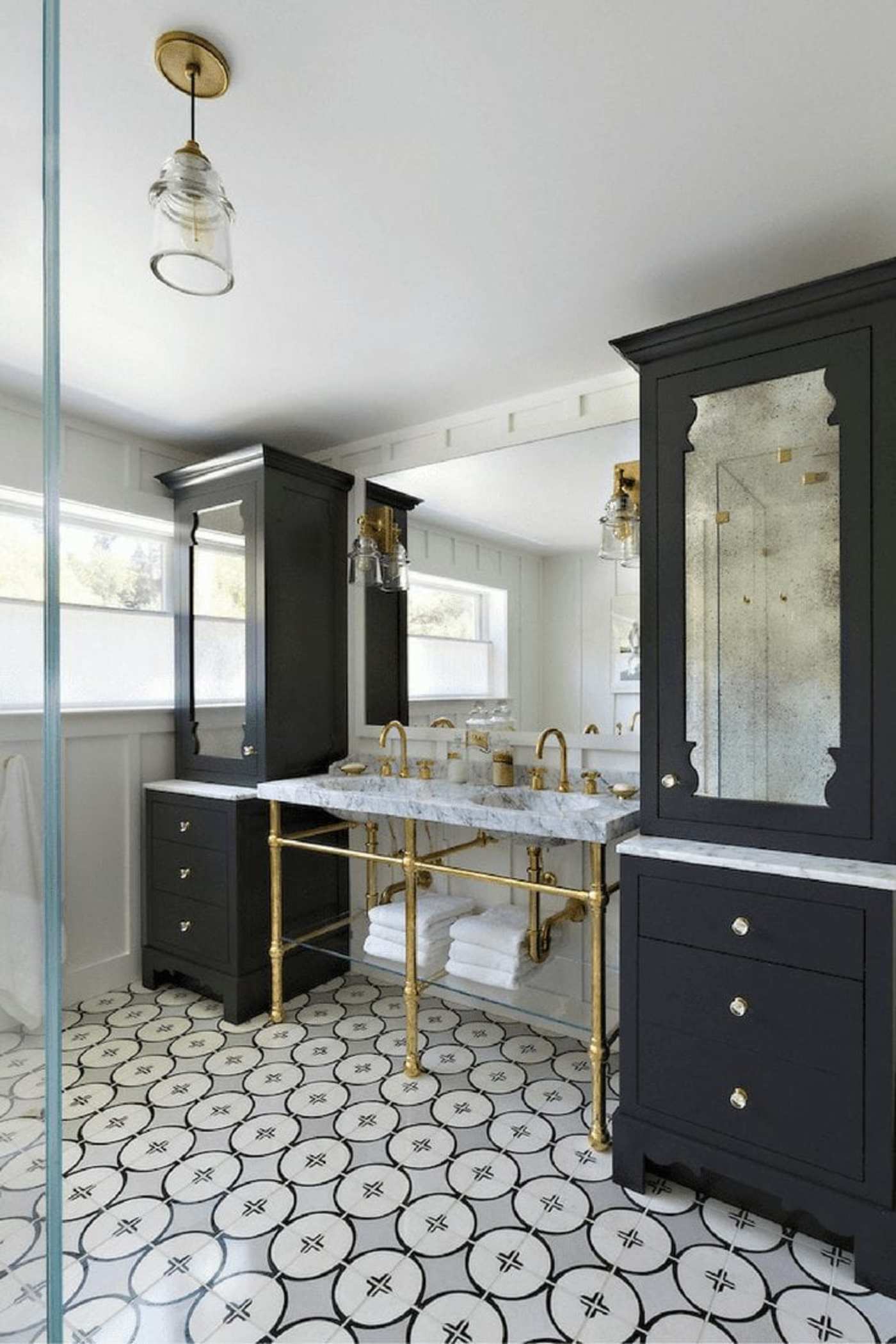 a bathroom with a black and white tile floor.