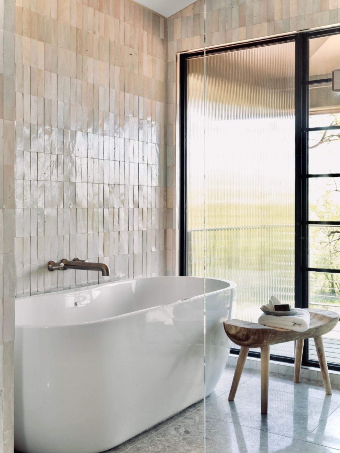 a bathroom with a large tub and a large window.