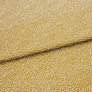 Mustard-yellow fabric with dense small white dot clusters; folded once across the center and lying flat as a close-up textile sample under neutral studio lighting.