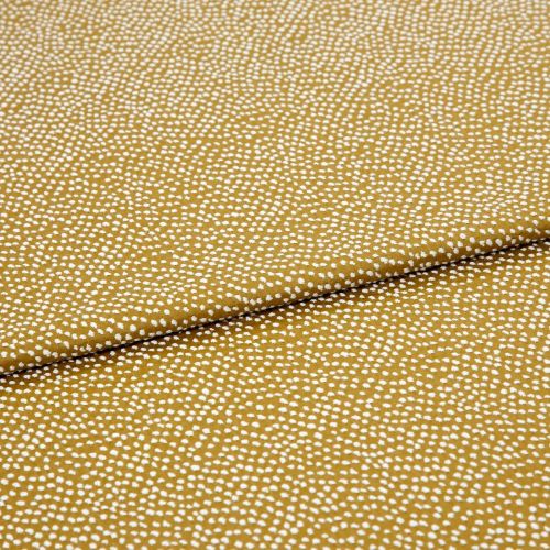 Mustard-yellow fabric with dense small white dot clusters; folded once across the center and lying flat as a close-up textile sample under neutral studio lighting.