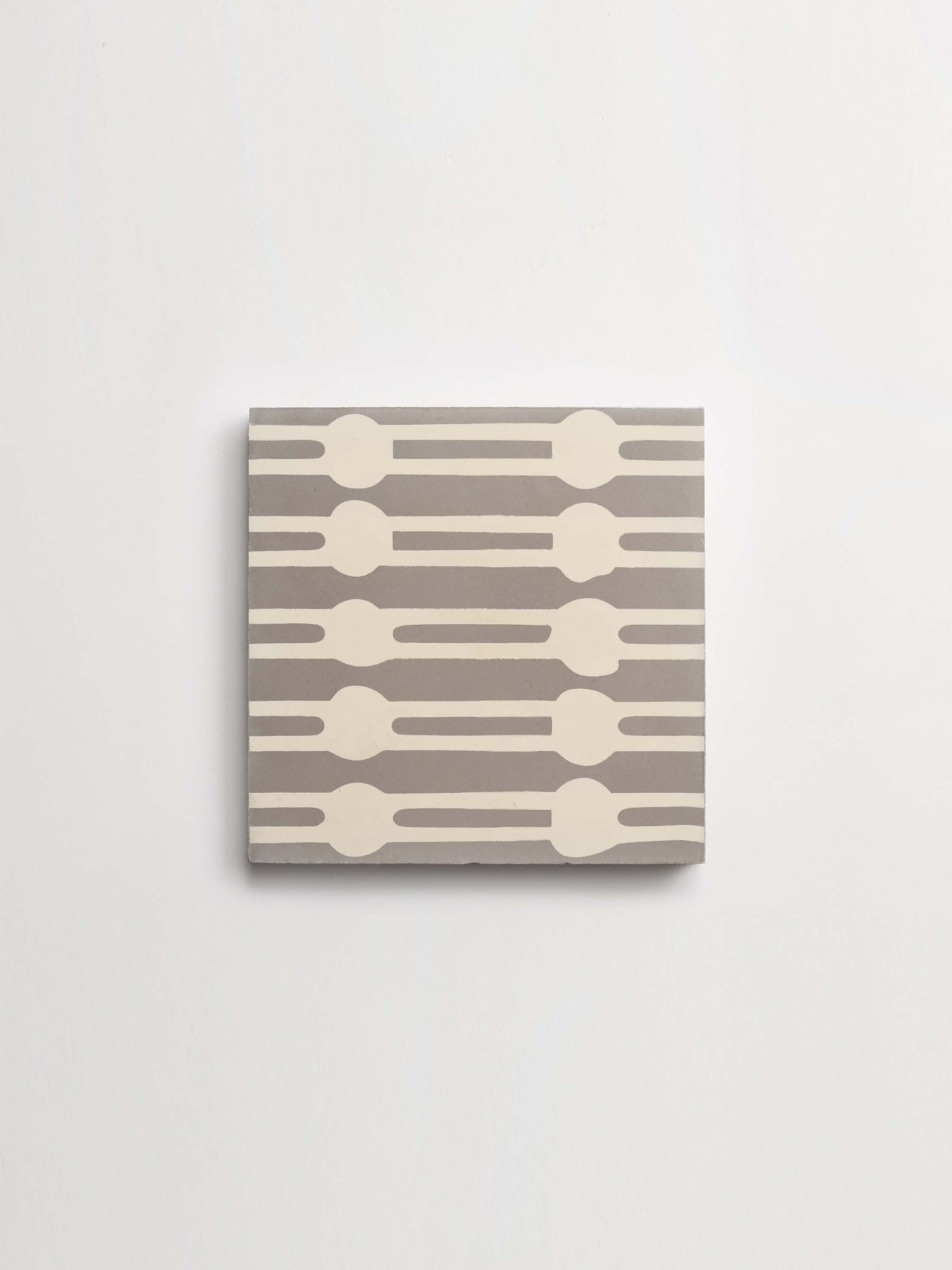 a grey and white patterned tile on a white background.