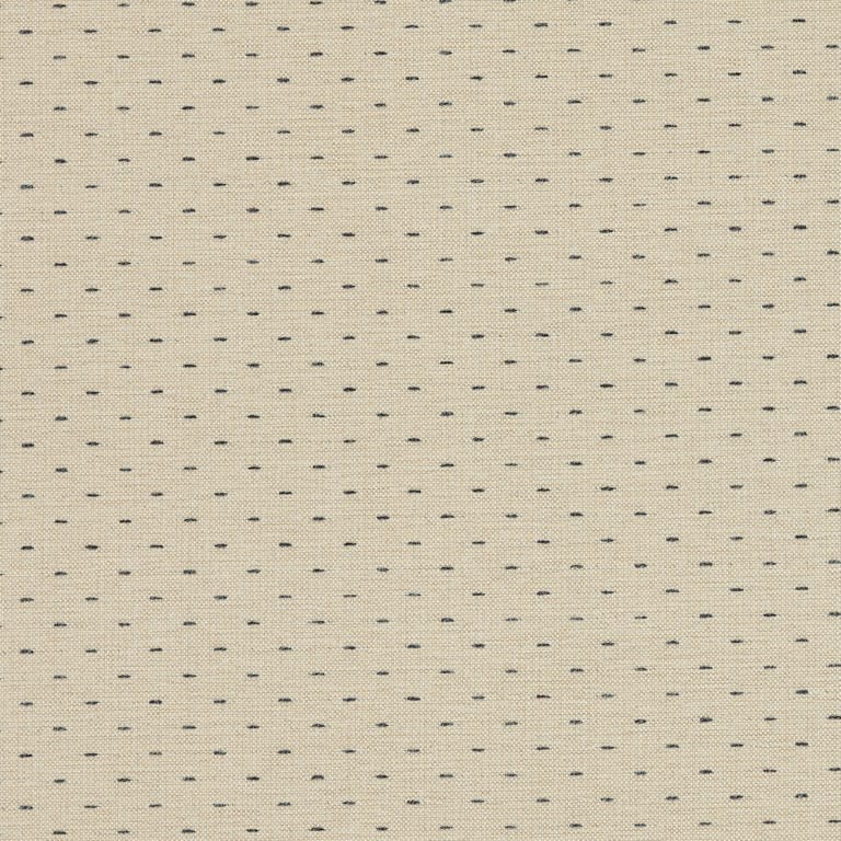 Beige woven fabric patterned with evenly spaced short navy-blue stitch dashes; close-up view showing textured weave and a subtle vertical seam, likely upholstery or curtain material in neutral indoor lighting.