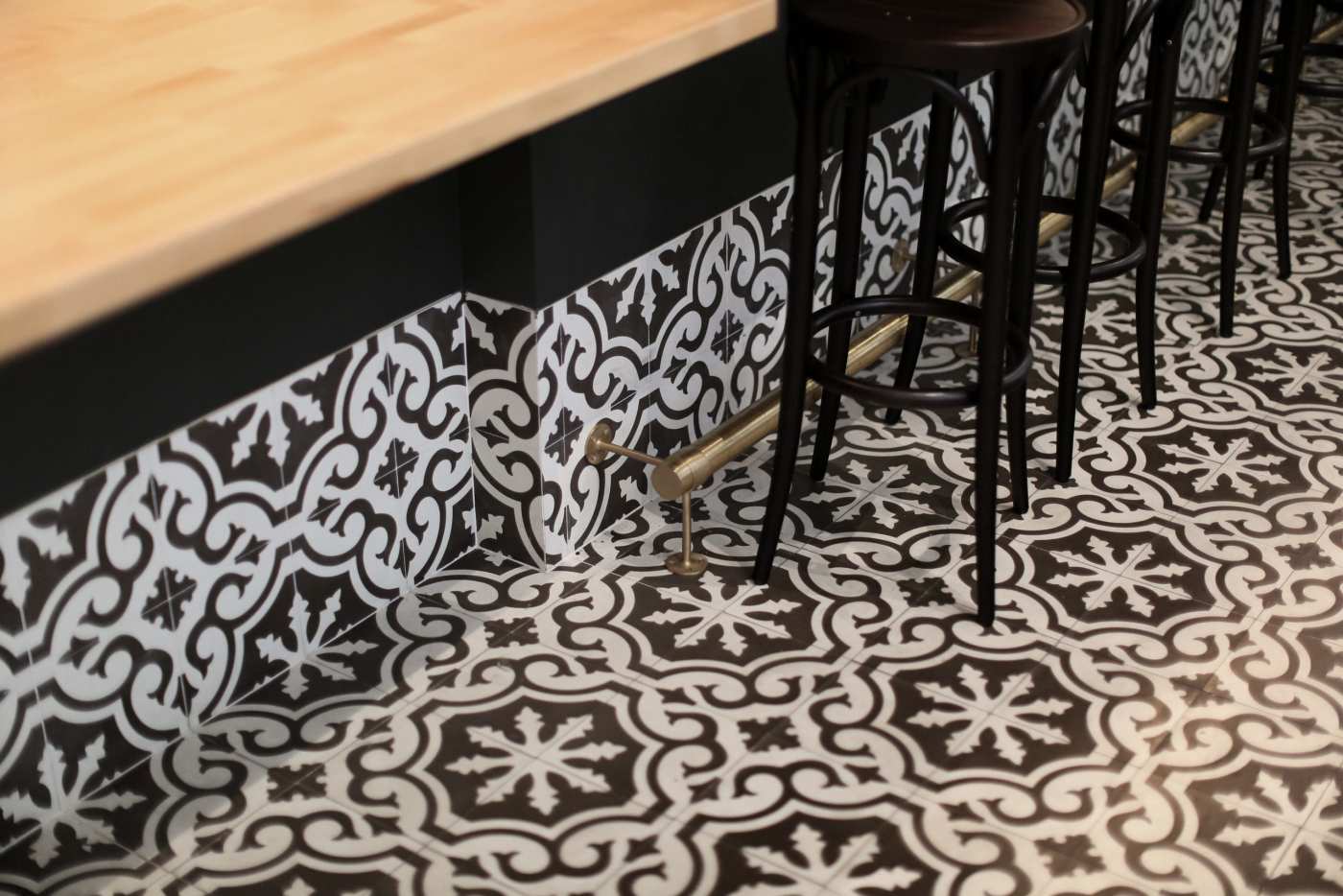 a black and white tiled floor in a bar.