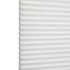 White honeycomb (cellular) blind with horizontal pleats, closed and softly diffusing daylight; minimal, bright interior with no visible furniture or view.