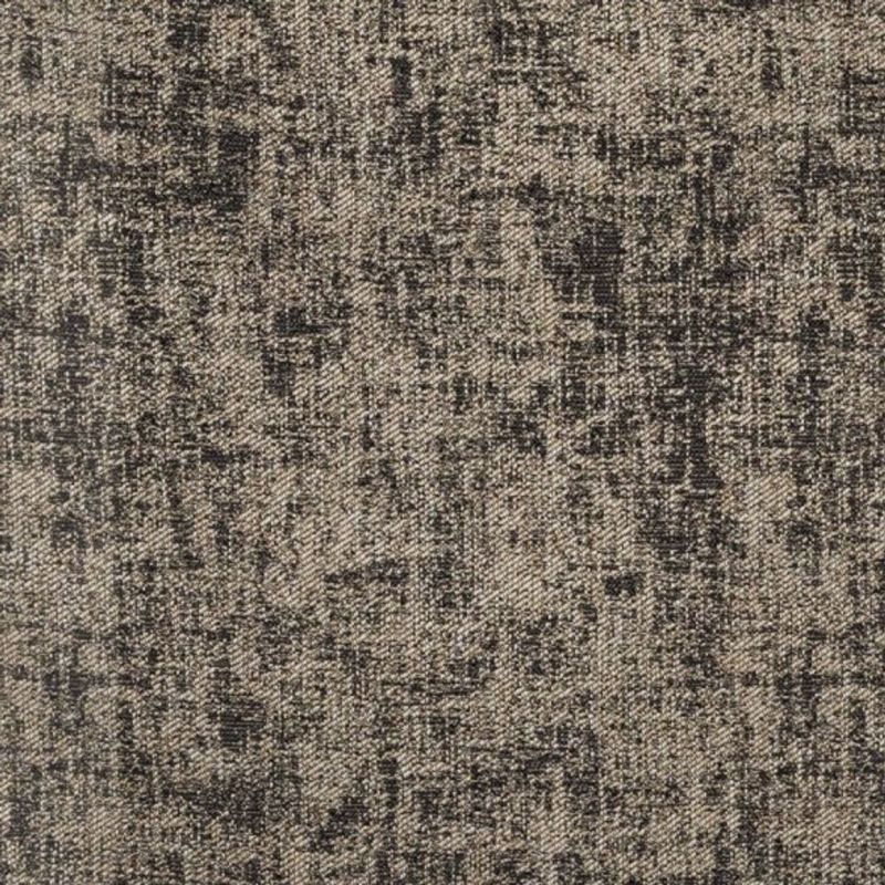 Woven gray-beige upholstery fabric close-up showing irregular black crosshatch and speckled pattern, revealing a coarse diagonal twill weave texture across a flat, evenly lit surface.