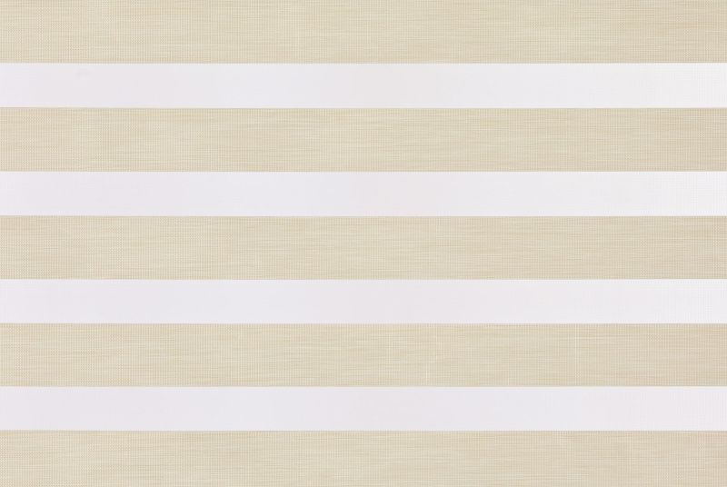 Horizontal dual-layer zebra roller blind with alternating opaque white and sheer beige textured bands, partially closed, filtering soft daylight in a neutral-lit interior.