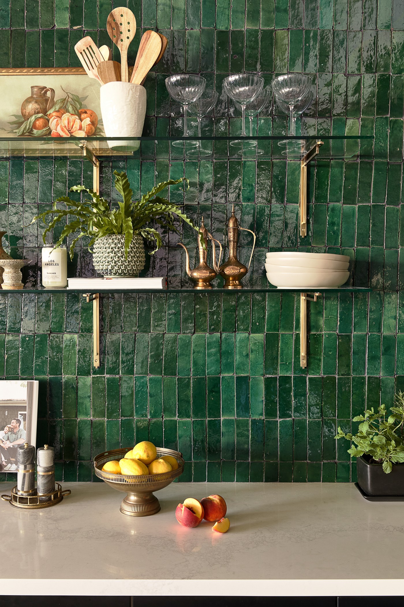 a kitchen with green tiled backsplash.