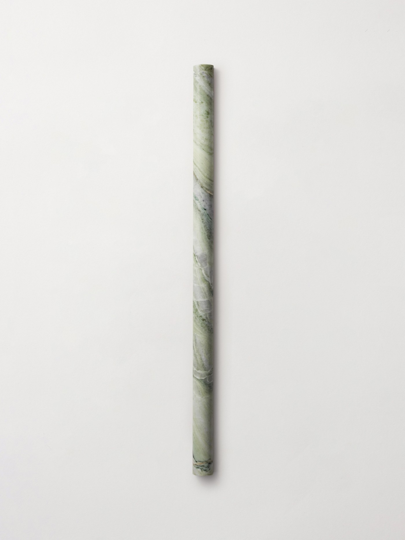 A single  long linear, curved convex stone tile in color Jade Green, from clÃ©âs Lapidary collection featuring 3d sculpted (fluted and rounded) shapes.