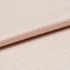 Light peach woven fabric with tight basket weave, folded in a shallow overlap; soft sheen catches diffused studio light, close-up view emphasizing texture and gentle drape.