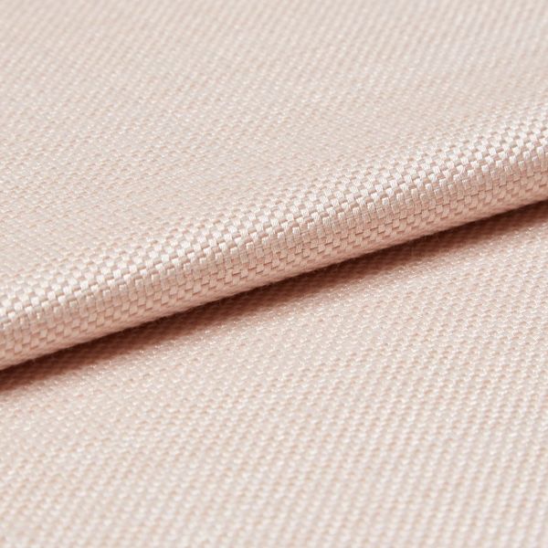 Light peach woven fabric with tight basket weave, folded in a shallow overlap; soft sheen catches diffused studio light, close-up view emphasizing texture and gentle drape.