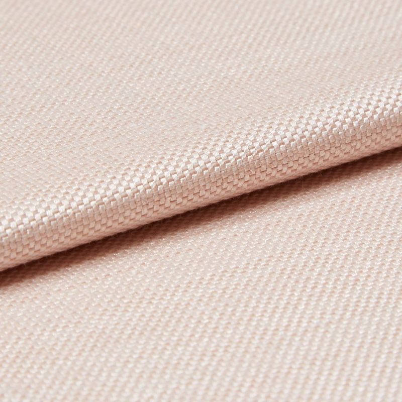 Light peach woven fabric with tight basket weave, folded in a shallow overlap; soft sheen catches diffused studio light, close-up view emphasizing texture and gentle drape.
