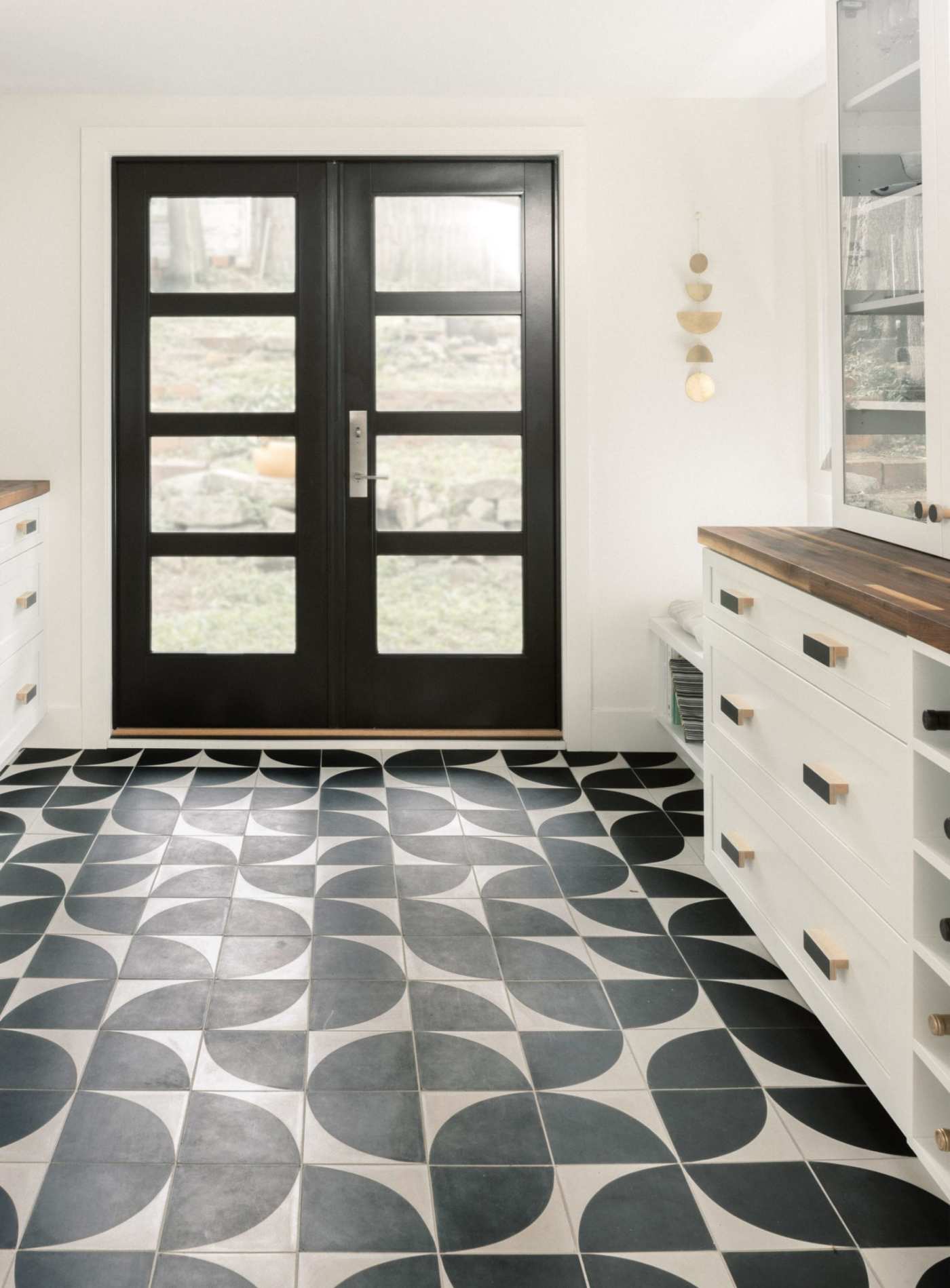 a kitchen with a black and white tile floor.