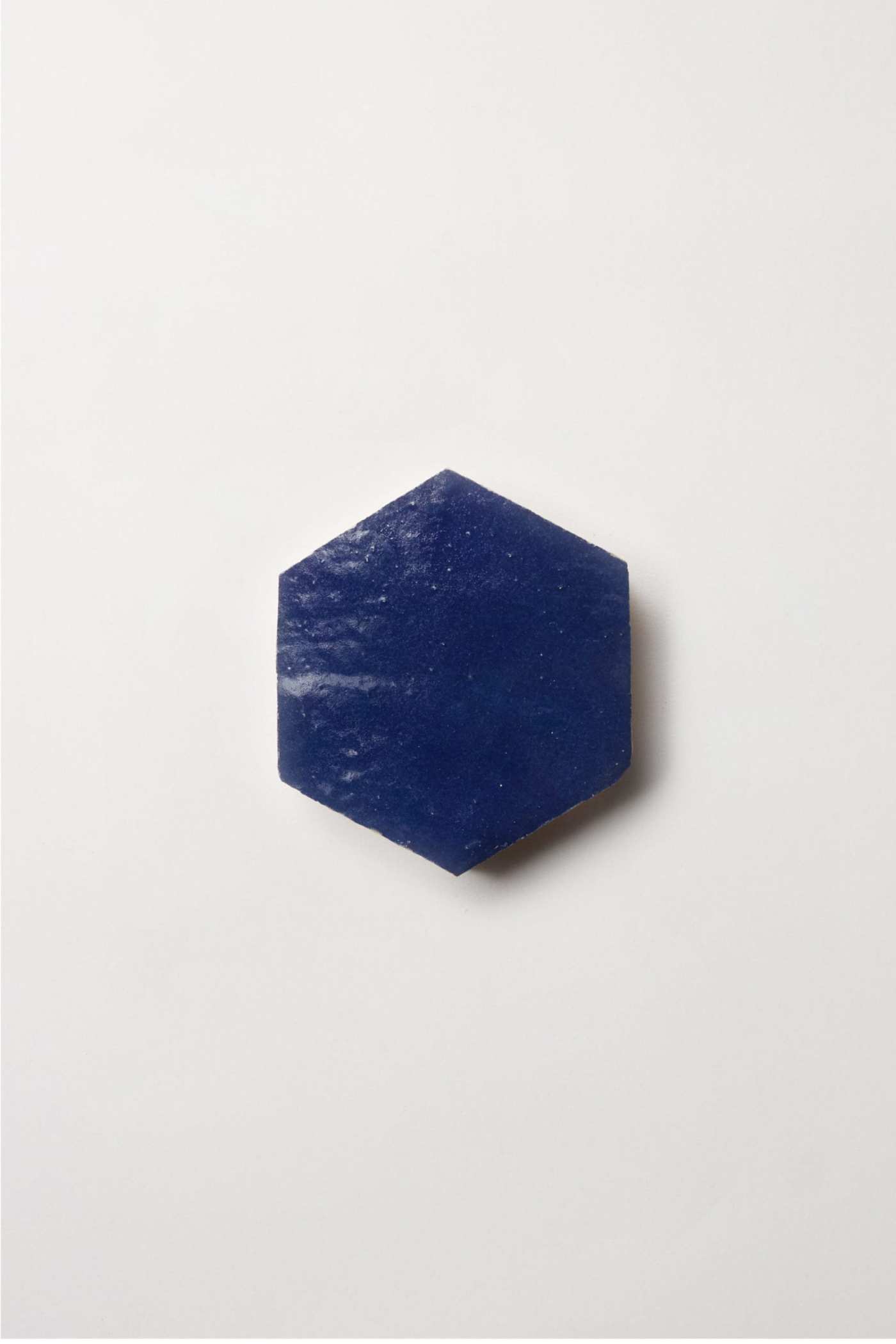 a blue hexagonal tile on a white background.