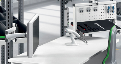 Raise monitors and keyboards off the work surface to maximize space and stay organized.