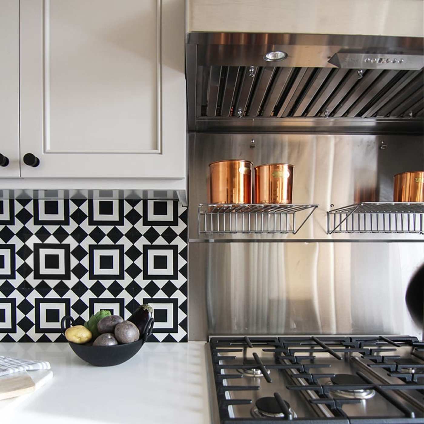 a black and white tiled backsplash in a kitchen.